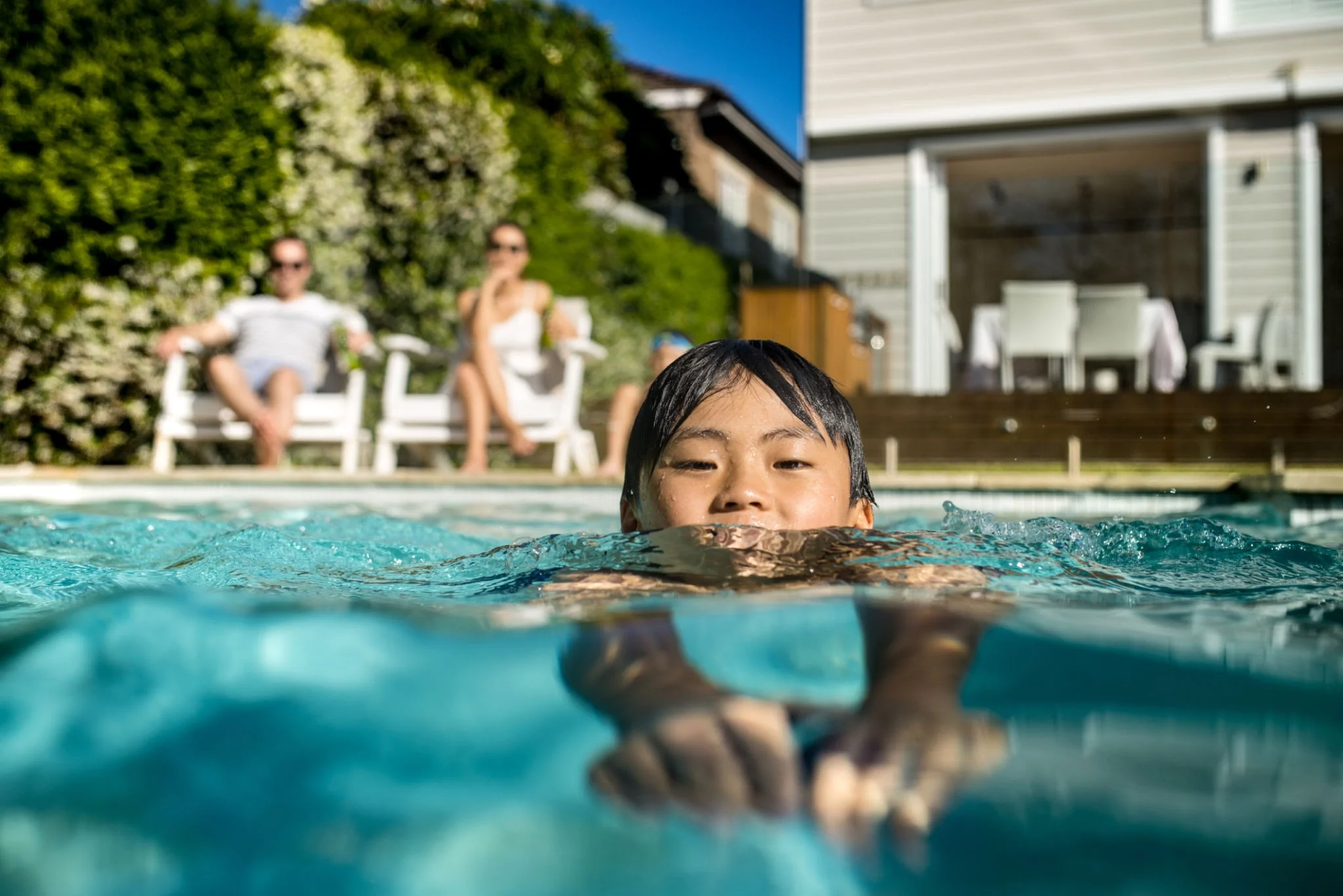 Pool Heating Systems Sydney | Expert Installation & Advice 241 Family enjoying heated swimming pool during Sydney winter evening